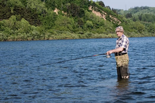 Fishing on the mountain river with fast current