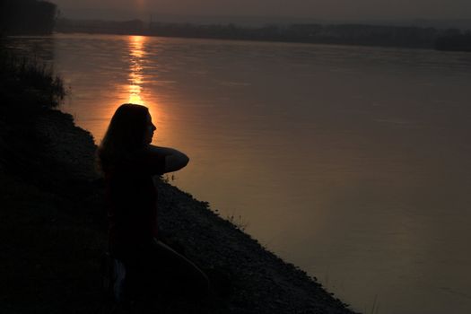 The girl in the evening at the river