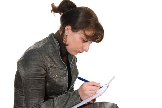 The girl on a white background does records in a notebook