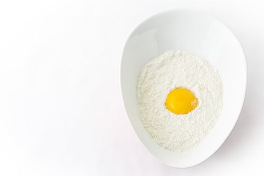 egg and flour in an egg shaped plate