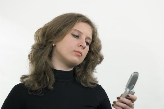 The girl with mobile phone on a white background