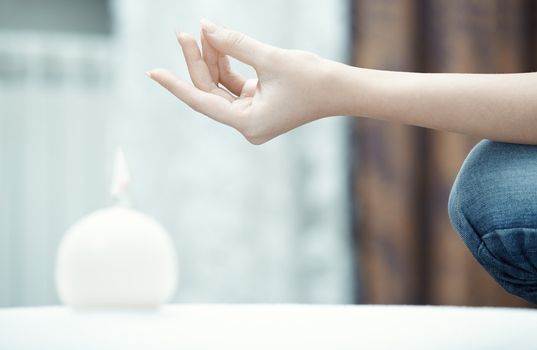 Hand of human practicing yoga at home