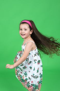 Portrait of the girl on a green background