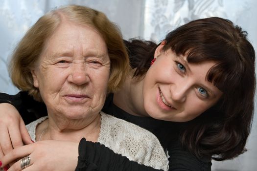 The grand daughter embraces the grandmother