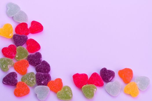 Love-shaped jelly on white background under purple gel illumination for background use