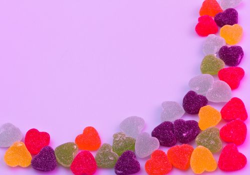 Love-shaped jelly on white background under purple gel illumination for background use