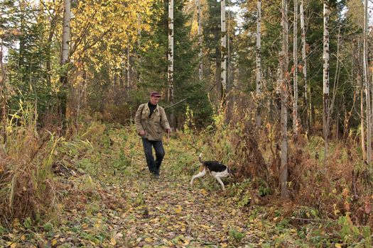 The hunter with the hunting dog leaves on hunting