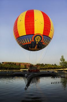 multi-colored air balloon at the lake, near Paris