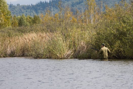 The hunter goes on lake in search of wild ducks