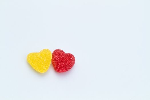 Yellow and Red Love-shaped jelly on white surface with copy space for backround use