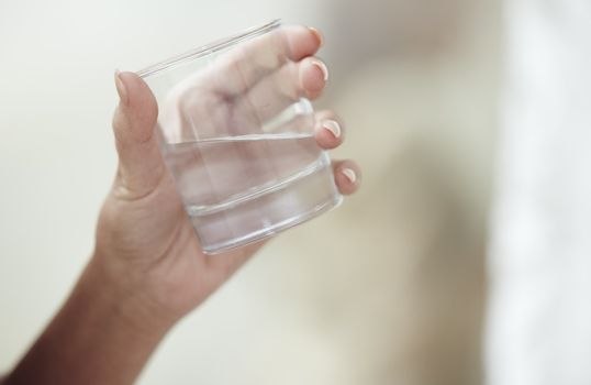 Woman holding glass with potable water