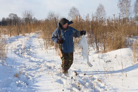 The hunter examines a hare killed on hunting