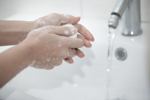 Human washing hands with soap. Close-up photo