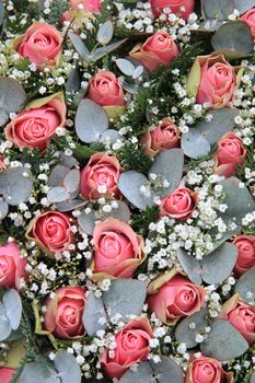 Floral arrangement with pink roses, gypsophila and eucalyptus