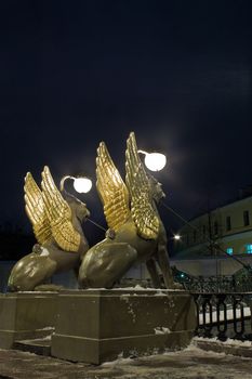 Night vertical view of Griffons on Bank Bridge in st. Petersburg, Russia