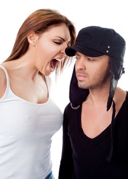 Young woman screaming at man's ear on white background