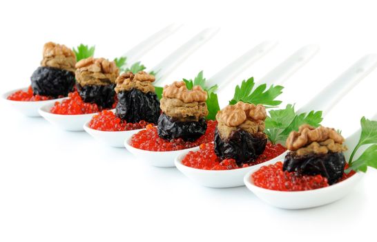 Prunes stuffed with liver pate with nuts in a red caviar