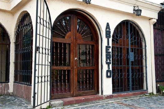 ancient door barred and the word "open" in Spanish