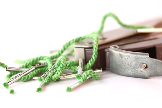 A hole punch sits with some string document ties.