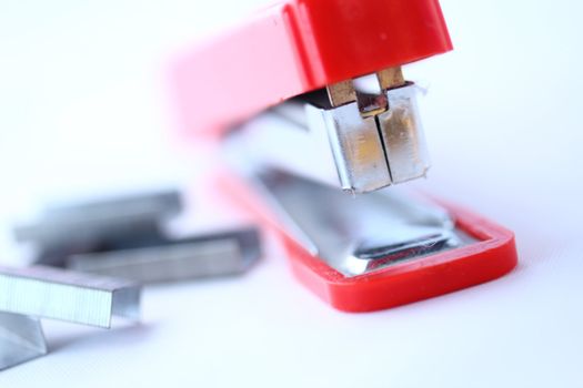 A stapler and staples sit athered together.