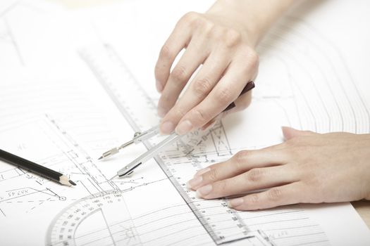 Hands of engineer working on a construction plan