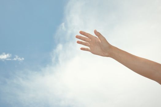 Human hand on a summer sky background