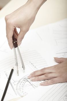 Hands of engineer working on a construction plan