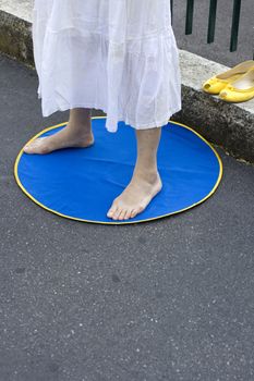 Feet of a woman meditating on a blue mat