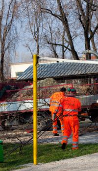 Worker in orange next to a truck