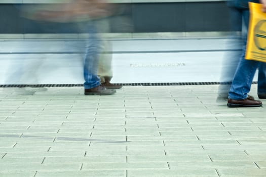 Photo of the feet that walk on the sidewalk