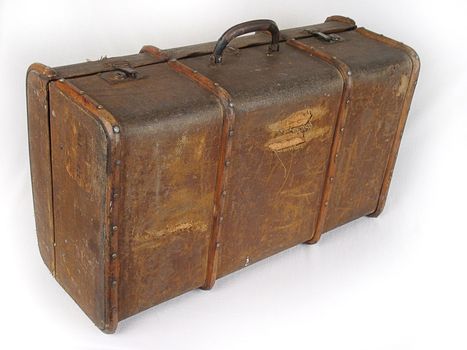 Old brown suitcase on a light background.