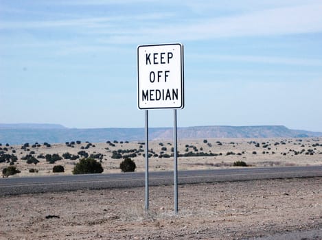 Keep off Median against a mountain landscape