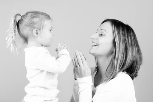 Beautiful mother and toddler daughter playing together