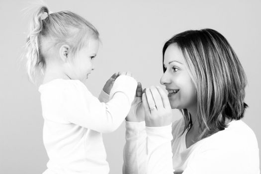 Beautiful mother and toddler daughter playing together