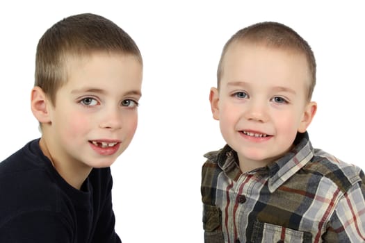 Two young brothers against a white background 