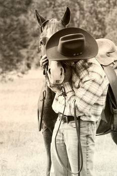 Cowboy with his horse in the field 