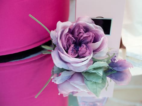 Pink flower and perfume on glass
