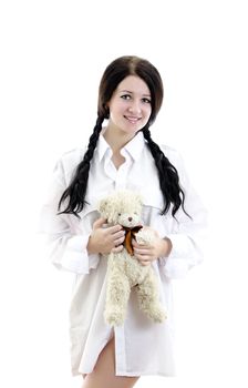 Sensual brunette girl in man's shirt with Teddy Bear. Isolated on white.