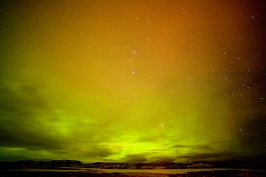 Surreal night sky of Northern Lights or Aurora borealis  thin clouds and stars over snowy winter landscape of Lake Laberge  Yukon Territory  Canada