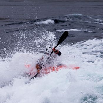 Kayaker mastering whitewater kayaking enjoying the extreme thrill of paddling fast currents  breaking waves and wild water