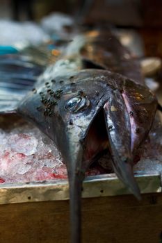The fastest fish in the ocean lies on a table covered in flies and sold off in chunks for  a BBQ in Thailand.