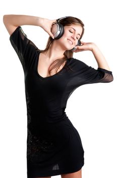 Woman dancing using headphones isolated in a white background