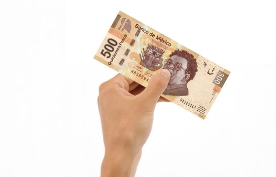 Hand holding 500 Mexican Pesos Bill islolated on white background.