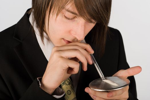 Guy snorting a line of cocaint through an empty pen