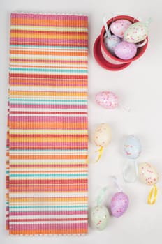 Striped napkin and easter eggs on light background