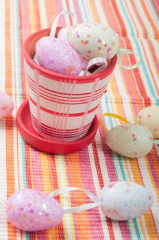 Flowerpot on the striped napkin with easter eggs