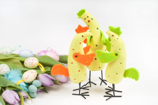 Easter chicken family with tulips and eggs on light background