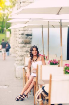 brunette woman sitting in cafe.