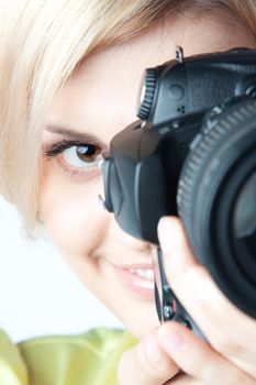 Young and beautiful girl with a professional camera in hand
