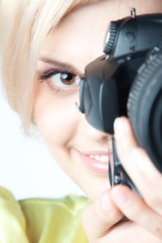 Young and beautiful girl with a professional camera in hand